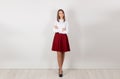 Successful and bold. Full length of happy young businesswoman with crossed arms, standing isolated against white wall. One single Royalty Free Stock Photo