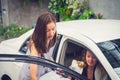 Successful business girl buy a new car at dealership store. Now she is sitting in a car and get some informations from saleswoman