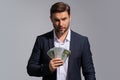 Successful business man counting money. Handsome middle age man holding bunch of 100 dollar banknotes. Guy holding money Royalty Free Stock Photo