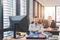 Successful business man with his staff in background at office Royalty Free Stock Photo