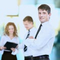 Successful business man standing with his staff in background Royalty Free Stock Photo