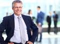 Successful business man standing with his staff in background at office Royalty Free Stock Photo