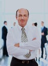 Successful business man standing with his staff in background at office. Royalty Free Stock Photo