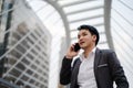 Successful business man in suit talking a mobile phone in city Royalty Free Stock Photo