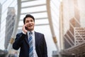 Successful business man in suit talking a mobile phone in city Royalty Free Stock Photo