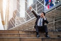 Successful business man talking a mobile phone with arm raised in city Royalty Free Stock Photo