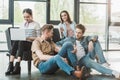 Successful business people resting and using gadgets in modern