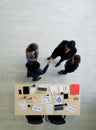 Successful Business People shaking hands in the modern office. Laptop computer, tablet, mobile phone, coffee cup and document are Royalty Free Stock Photo