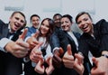 Successful business people with thumbs up and smiling. Royalty Free Stock Photo