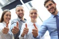 Successful business people with thumbs up and smiling Royalty Free Stock Photo