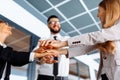 Successful business team celebrating a victory by folding their hands together, unity and teamwork concept Royalty Free Stock Photo