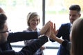 Successful business team giving each other high five standing in the office Royalty Free Stock Photo