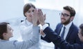 Successful business team giving each other a high-five, standing in the office Royalty Free Stock Photo