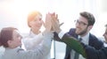 Successful business team giving each other a high-five, standing in the office Royalty Free Stock Photo