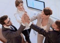 Successful business team giving each other a high-five, standing in the office Royalty Free Stock Photo