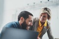 Successful business team at work. Group of young business people working with laptop and communicating together in Royalty Free Stock Photo