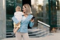 Portrait of a successful business woman in blue suit with baby Royalty Free Stock Photo