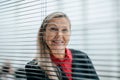 Successful business woman looks through an office window Royalty Free Stock Photo