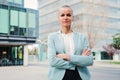 Successful business woman standing arms crossed at workplace looking at camera. Corporate female or employee folded Royalty Free Stock Photo