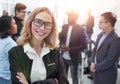 Successful business woman standing with her staff in backgroun Royalty Free Stock Photo