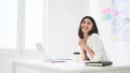 Successful business woman working in a workplace. She feels happy and smiles Royalty Free Stock Photo