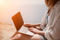 Woman sea laptop. Successful business woman working on laptop by the sea. Pretty lady typing on computer at summer day Royalty Free Stock Photo