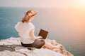 Woman sea laptop. Successful business woman working on laptop by the sea. Pretty lady typing on computer at summer day Royalty Free Stock Photo