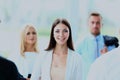 Successful business woman standing with her staff in background at office. Royalty Free Stock Photo