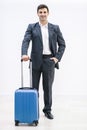 Successful businessman at airport pulling trolley bags ready for international business trip. Royalty Free Stock Photo