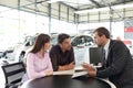 Successful businessman in a car dealership - sale of vehicles to Royalty Free Stock Photo