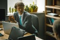 Successful businessman clasped palms seriously looking at colleague. Caucasian man in formalwear sitting at office desk