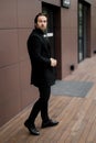 Successful businessman in formal stylish suit standing outside the office, looking at the side, posing for photography Royalty Free Stock Photo