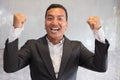 Successful businessman gesturing with happiness and gladness at