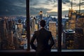 Successful businessman looking out of window at big night city view Royalty Free Stock Photo