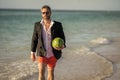 Successful businessman man on summer business vacation at sea beach with watermelon, copy space
