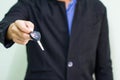 Successful businessman offering a car key