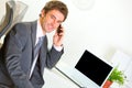 Successful businessman in office making phone call