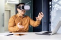 Successful businessman in online meeting uses vr glasses virtual reality, man communicates remotely with partners in Royalty Free Stock Photo