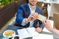 Successful businessman paying bill in cafe Royalty Free Stock Photo