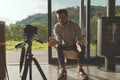 Successful businessman recording video concultation with camera and tripod Royalty Free Stock Photo