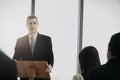 Successful businessman sharing experiences and giving a speech  group of business people sitting on conference together listening Royalty Free Stock Photo