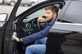 Successful businessman sits behind the wheel of a prestigious car Royalty Free Stock Photo