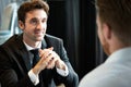 Successful businessman smiling while discussing with partner during meeting at coffee break Royalty Free Stock Photo