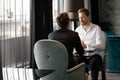 Successful businessman smiling while discussing with partner during meeting at coffee break Royalty Free Stock Photo