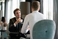 Successful businessman smiling while discussing with partner during meeting at coffee break Royalty Free Stock Photo