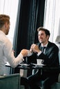 Successful businessman smiling while discussing with partner during meeting at coffee break Royalty Free Stock Photo