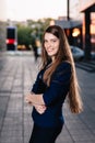 Successful businessman smiling, standing on the background of buildings and holding a tablet computer. City business woman working Royalty Free Stock Photo