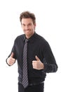 Successful businessman smiling thumbs up