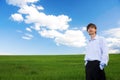 Successful businessman standing on grassland