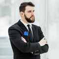 Successful businessman standing near a window in bright office. Royalty Free Stock Photo